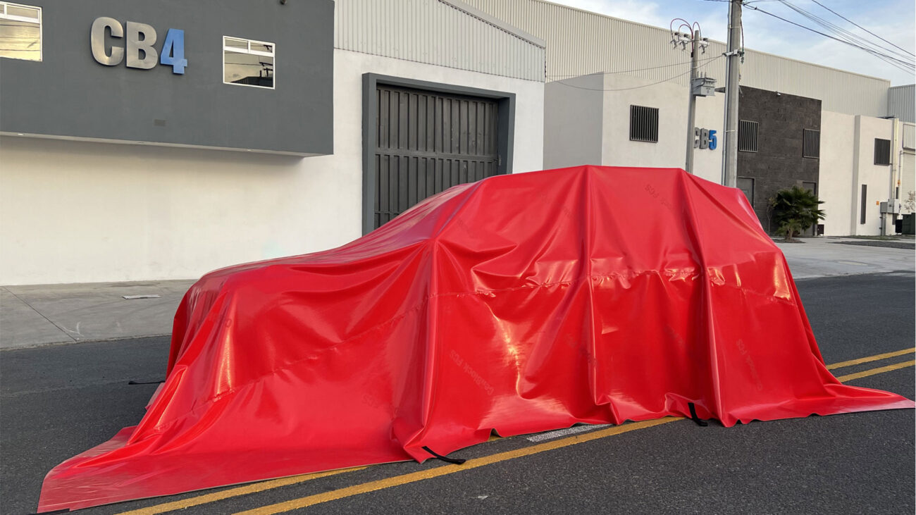 red fire blanket over an electric vehicle